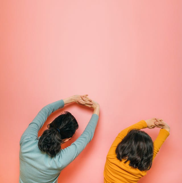 mother and daughter doing stretching together