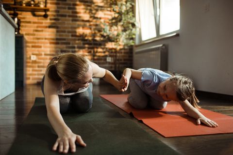 mother and daughter doing yoga