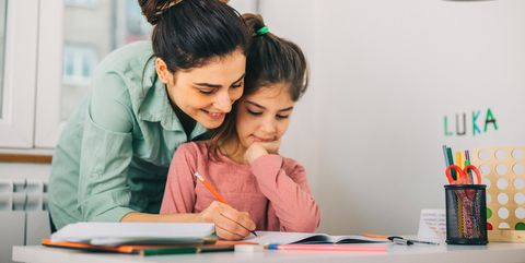 Mother Helping Her Daughter While Studying