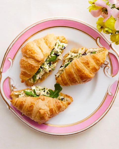 pesto chicken salad croissants on pink and white plate
