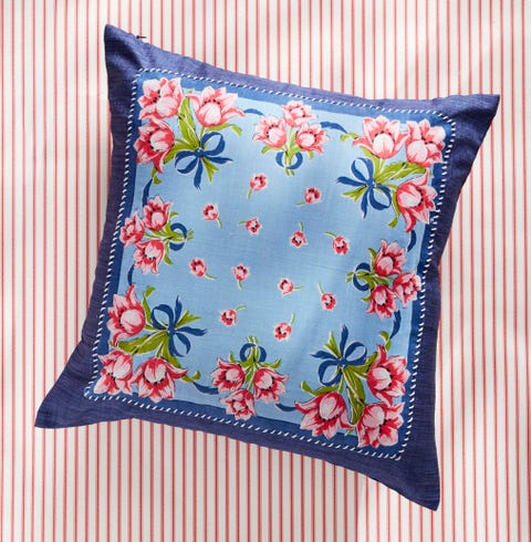 navy throw pillow with a blue, pink, and green floral handkerchief whipstiched to the front
