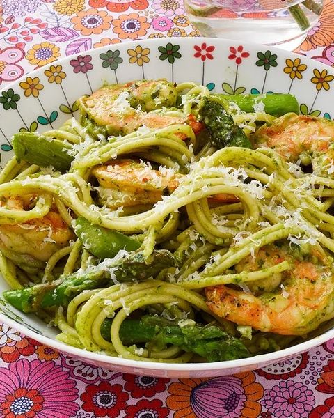shrimp pesto pasta in bowl with pink floral background