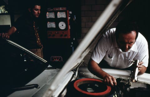 september 1975 motorist in the left background waits as an employee of an auto emission inspection station in downtown cincinnati tries to locate why the vehicle failed its inspection091975