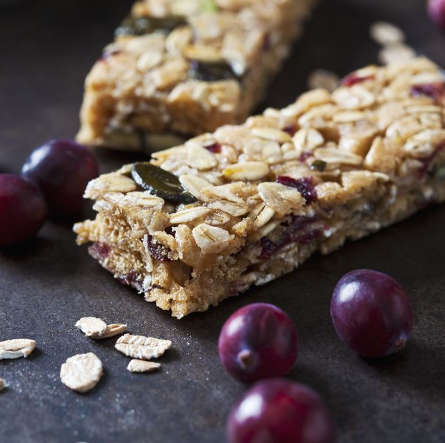 muesli bars with cranberries and oat flakes on dark background