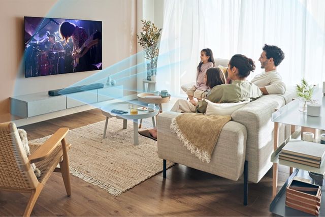 a family watching tv in a living room