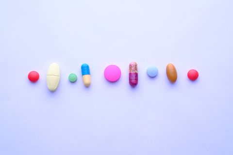 multi color pills,tablets and capsules on white background