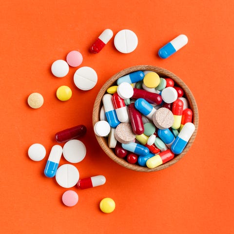 Multi-colored pills scattered on a bright background, a place for text. Multi-colored pills scattered on a bright background, a place for text.