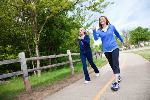 multi generational women walking together on a trail