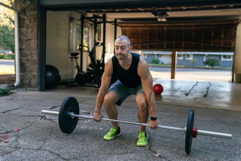 muscular man exercising at home in driveway