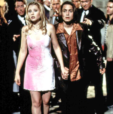 scene of hallie wearing a pink dress, black heels, and a rainbow necklace in my date with the president