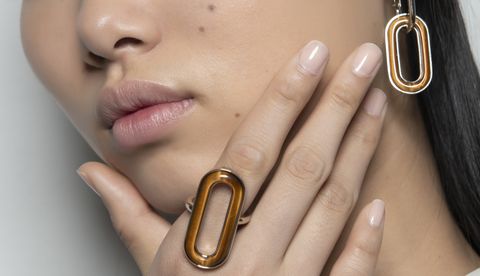 Brass instrument, Lip, Finger, Hand, Close-up, Nail, Metal, Fashion accessory, Mouth, Material property, 