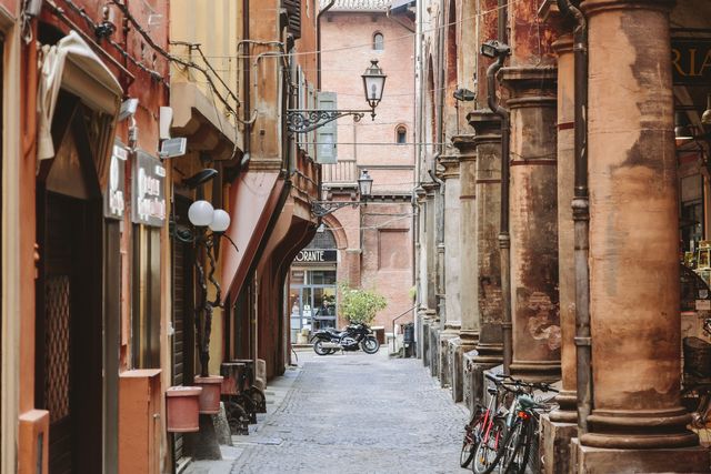 narrow cobbled street in the old town of bologna, italy