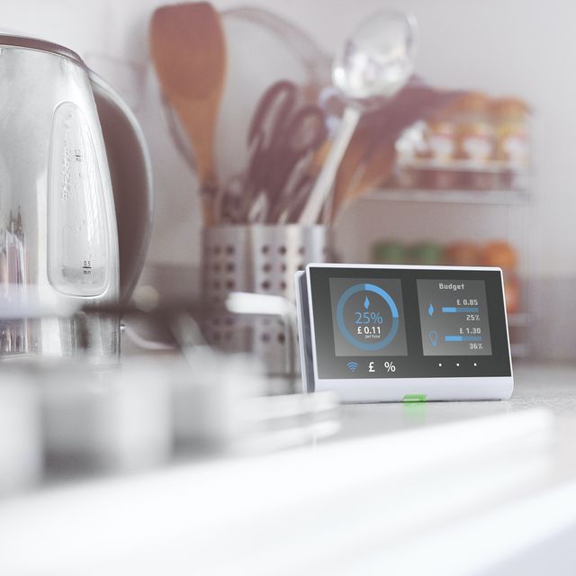 smart meter in the kitchen of a home showing current energy costs for the daydesign on screen my own please see property release