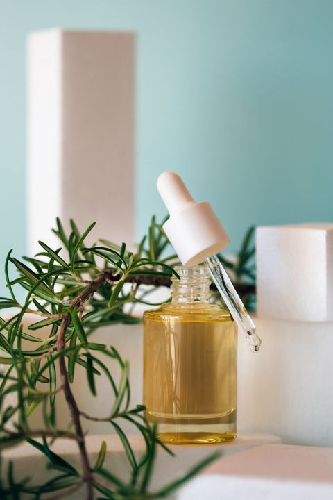 natural hair treatment bottle of rosemary oil