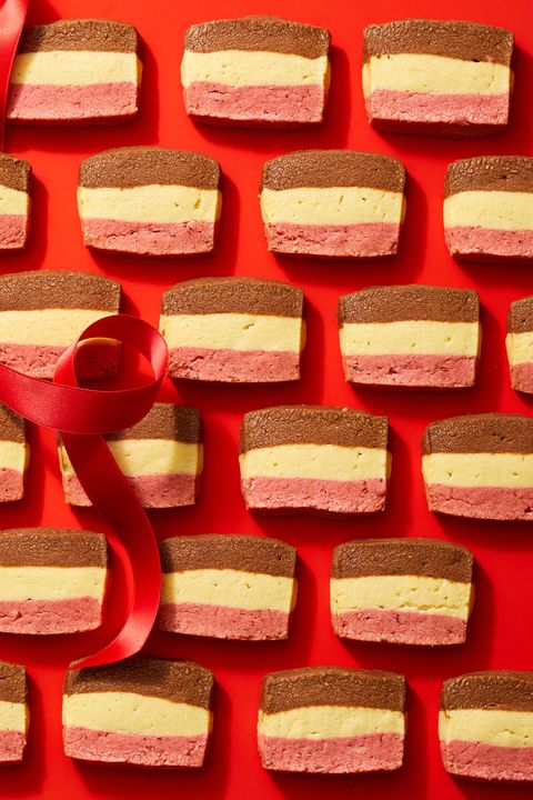 neapolitan cookies lined up in rows on a red background