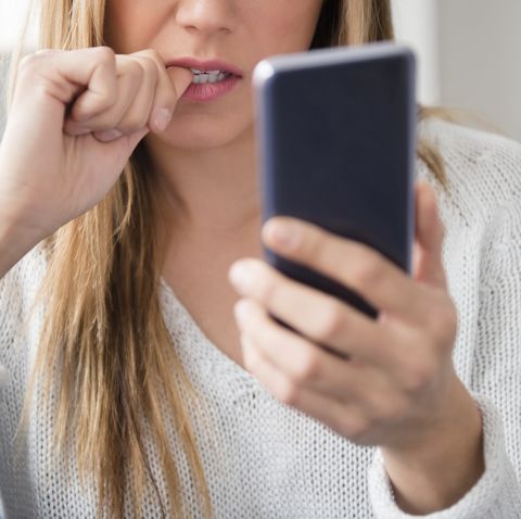 nervous young woman using smart phone
