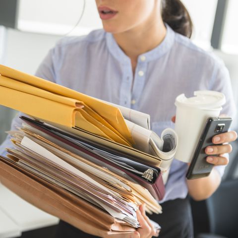 usa, new jersey, jersey city, business woman holding stack of documents in office