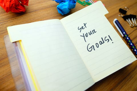 new year goals written on note pad on table