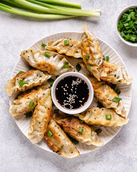 fried dumplings gyoza with soy sauce, and chopsticks, top view