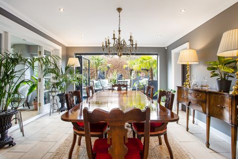 dining room with dark wood table and chairs and bi folding doors to garden