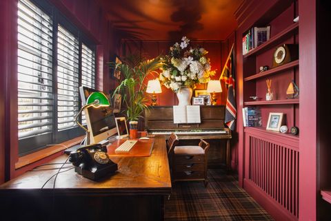 dark red study with desk and piano