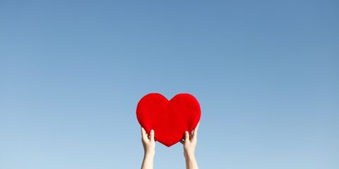 listening to heartbeat can improve body image; hand holding up a paper heart