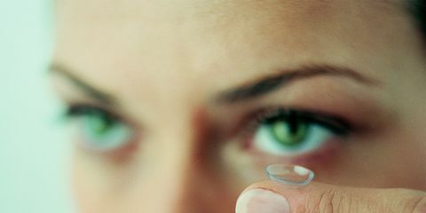 woman putting in contact lens