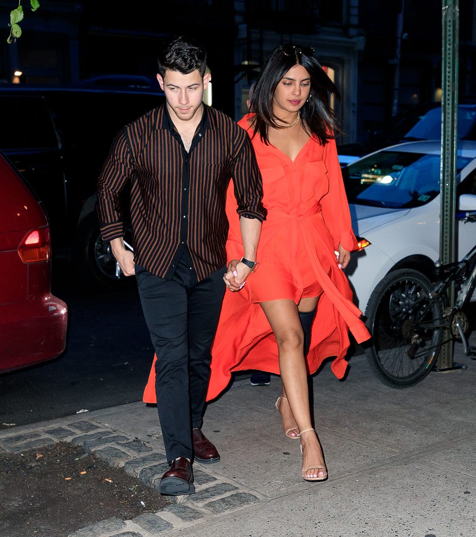 Priyanka Chopra Wears Orange Dress and Knee Brace For Date Night With Nick Jonas