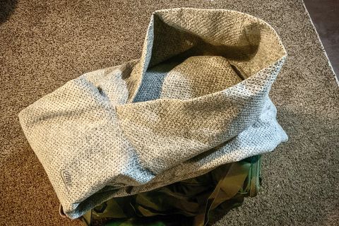 A folded Nike hoodie over a green duffel bag
