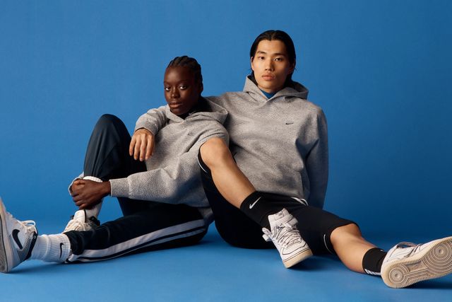 two people sitting while wearing nike apparel