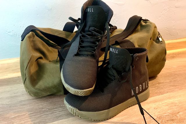 nobull shoes next to a duffle bag