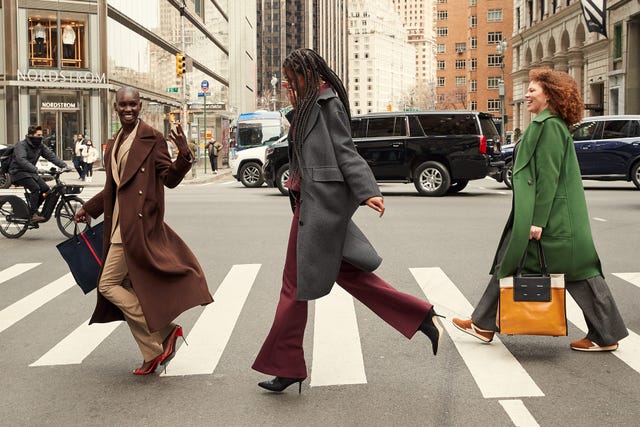 Three women cross the road