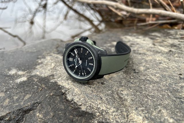 a watch on a rock near water