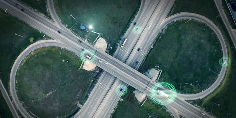 gps navigation and autonomous driverless transportation concept aerial view of transport junction with cars and trucks driving with digital green circles, future global technology on roads