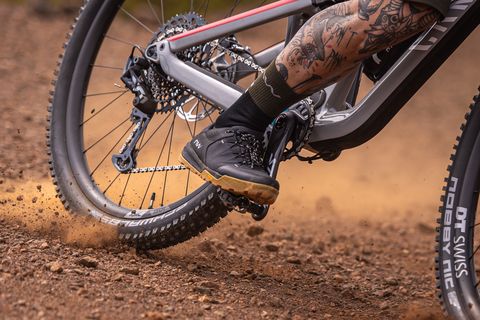 person riding bike through dirt wearing northwave shoes