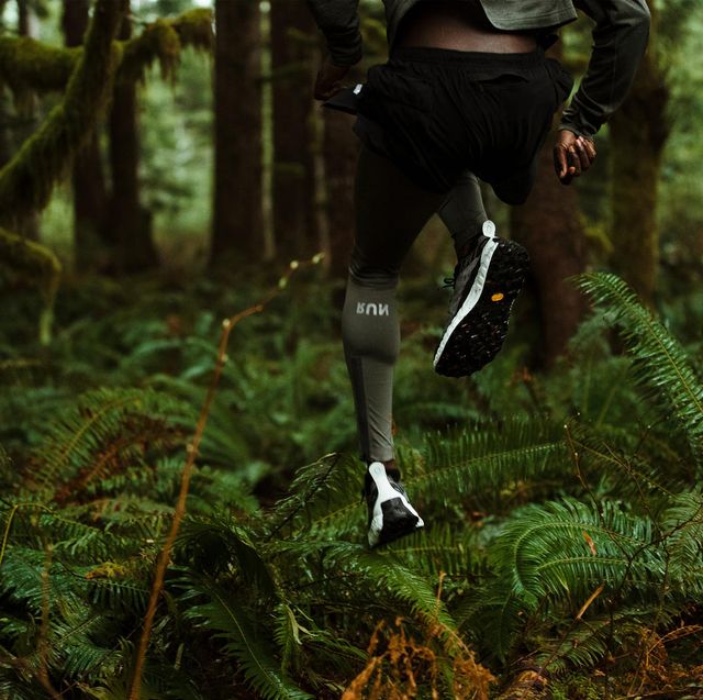 man running in forrest wearing norda 001 shoes