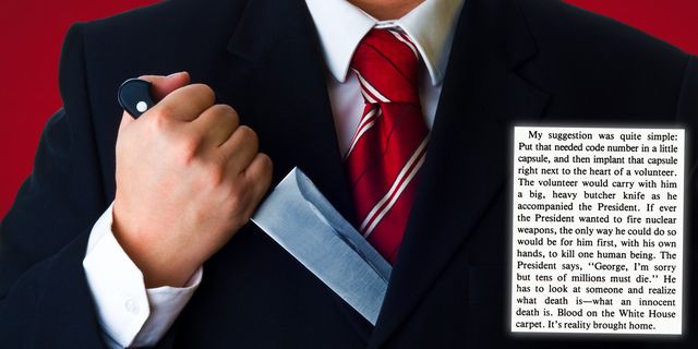 man in business suit holding a knife