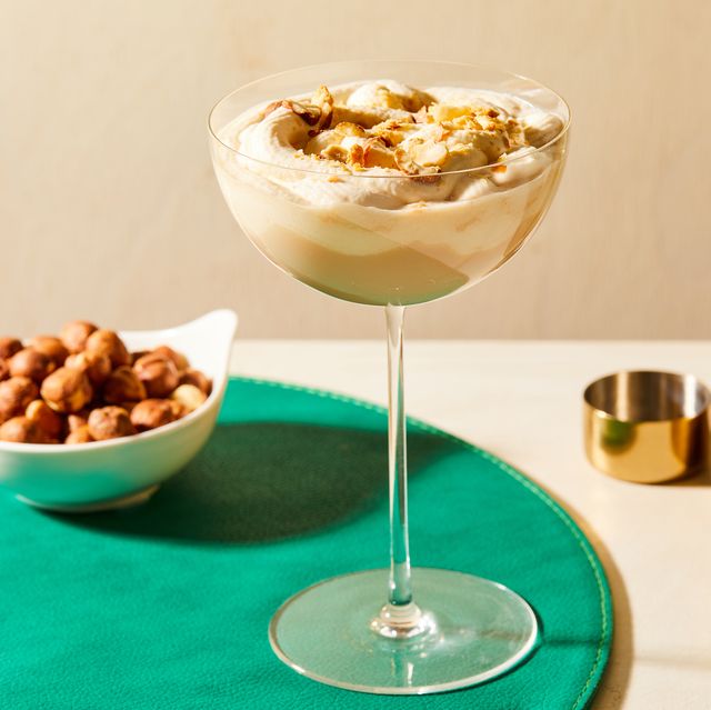 nutty irishman cocktail topped with crushed hazelnuts in a glass atop a green placemat
