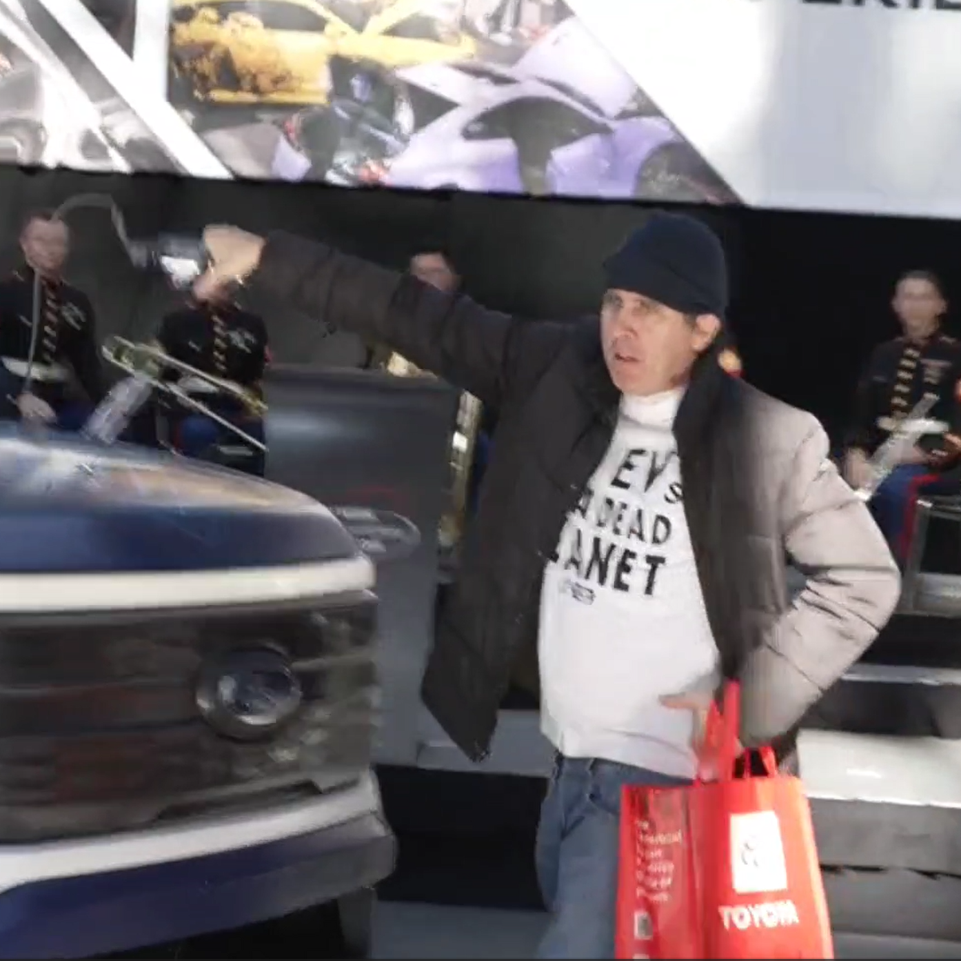 Climate Activists Dragged Out of New York Auto Show After Tossing Oil on EV