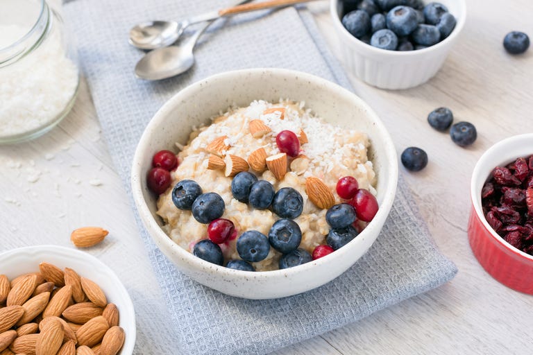 Oatmeal porridge bowl wtih blueberries, cranberries, almonds and coconut