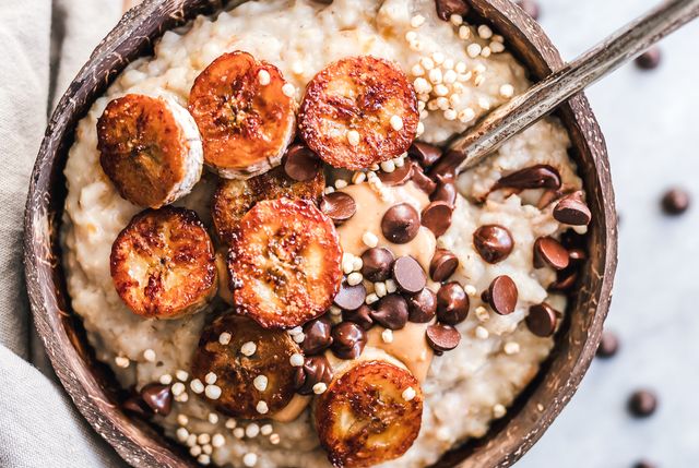 oatmeal with caramelized banana, nut butter, chocolate chips and puffed quinoa