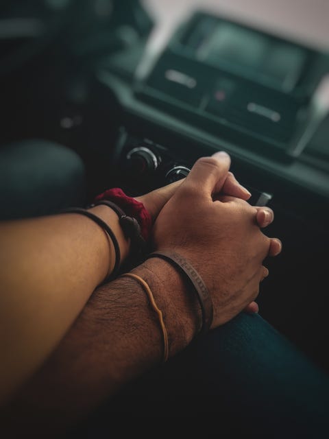 couple holding hands on road trip