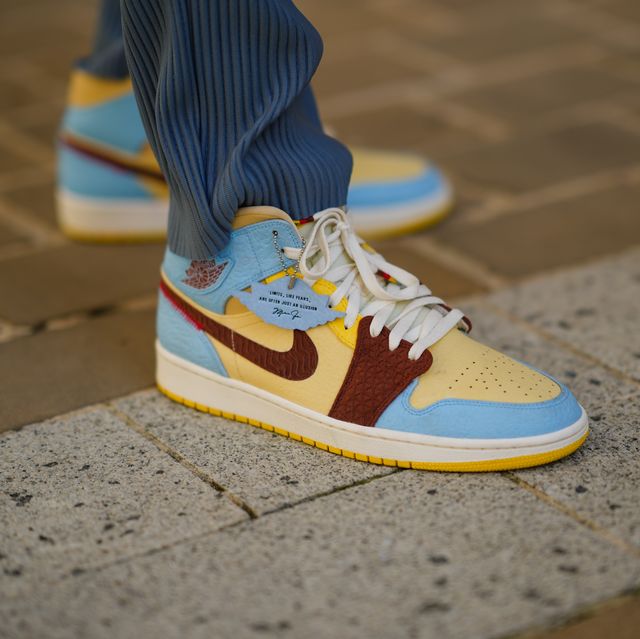 paris, france   august 01 cali chiki wears pale gray ribbed zara large pants, yellow  blue  burgundy  beige leather air jordan sneakers from nike x chateau rouge, on august 01, 2021 in paris, france photo by edward berthelotgetty images