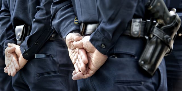 officers standing with hands behind