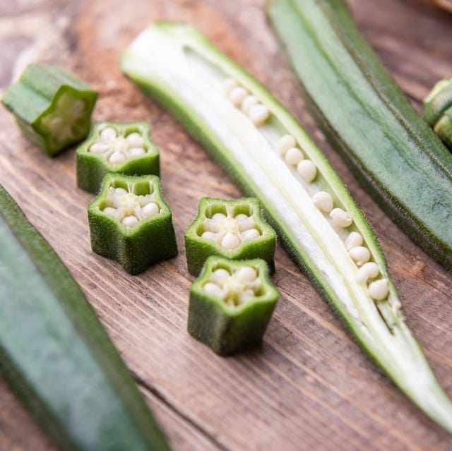 sliced okra on a wood cutting board