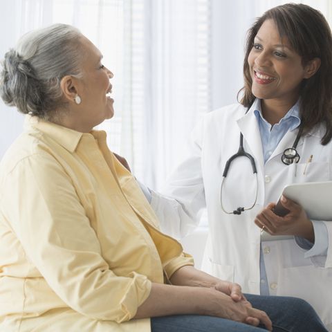 how to look younger older woman talking to doctor in office