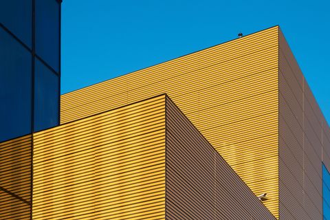 Blue, Architecture, Daytime, Yellow, Commercial building, Line, Sky, Facade, Building, Material property, 