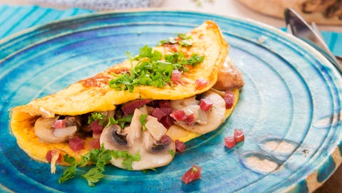 Omelette with champignon, onion and ham on plate Omelette with champignon, onion and ham on plate