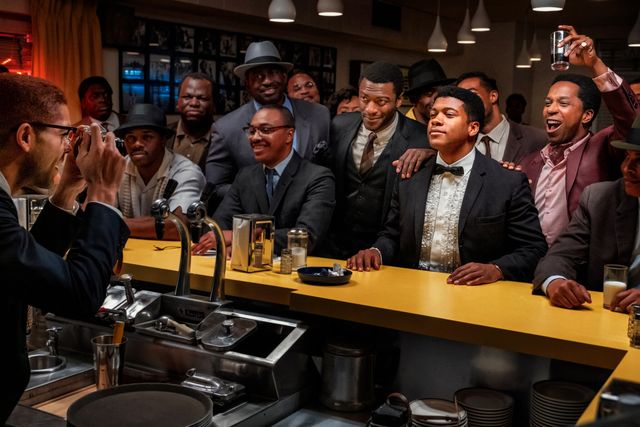 the cast of 'one night in miami' in a bar in a still from the movie