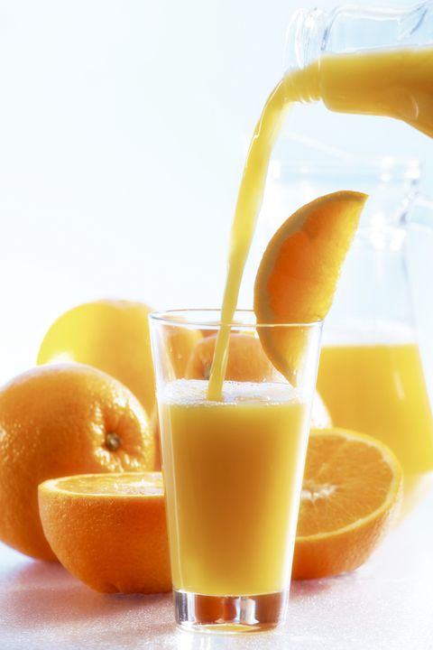 Orange juice been poured into glass